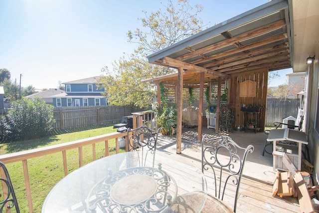 wooden deck featuring a lawn