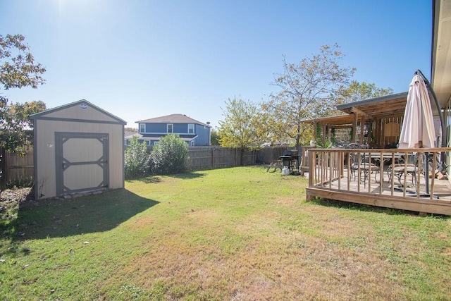 view of yard featuring a storage shed and a deck