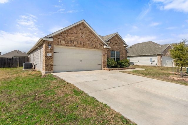 view of front of property with a garage, central AC, and a front yard