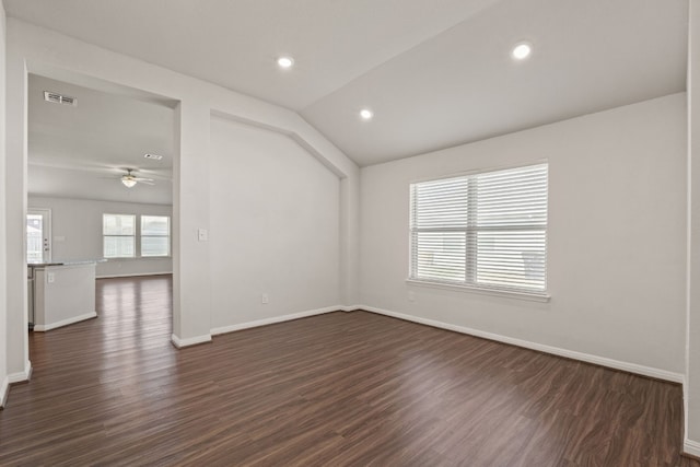 empty room featuring ceiling fan, lofted ceiling, and dark hardwood / wood-style floors