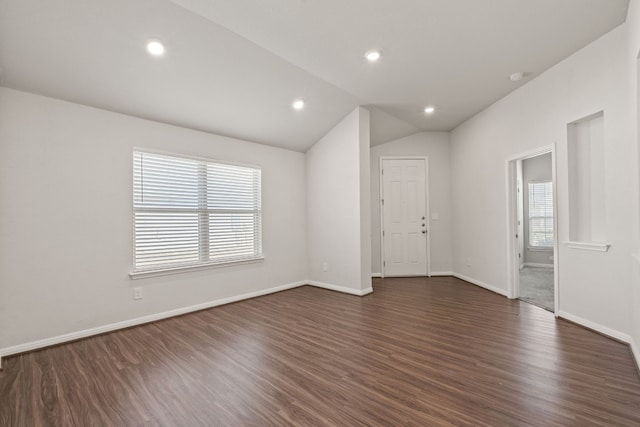 unfurnished room with lofted ceiling and dark hardwood / wood-style floors