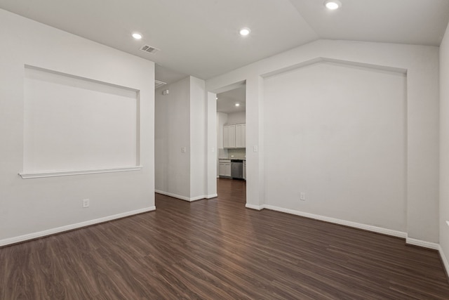 unfurnished room with dark wood-type flooring and vaulted ceiling