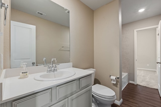 full bathroom with vanity, wood-type flooring, bathtub / shower combination, and toilet