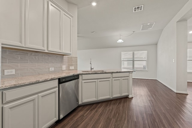 kitchen with stainless steel dishwasher, dark hardwood / wood-style flooring, kitchen peninsula, and sink