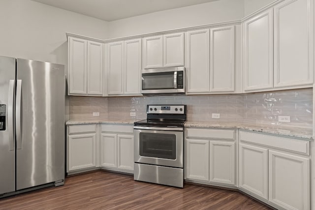 kitchen with stainless steel appliances, white cabinetry, dark hardwood / wood-style floors, and decorative backsplash