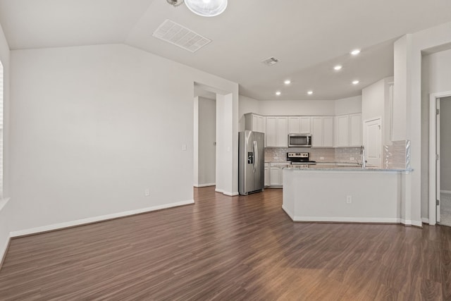 kitchen with white cabinetry, decorative backsplash, dark wood-type flooring, and appliances with stainless steel finishes