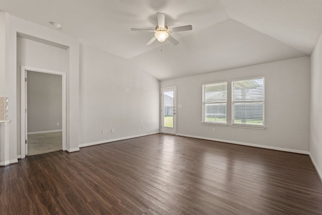 spare room featuring dark hardwood / wood-style flooring, vaulted ceiling, and ceiling fan