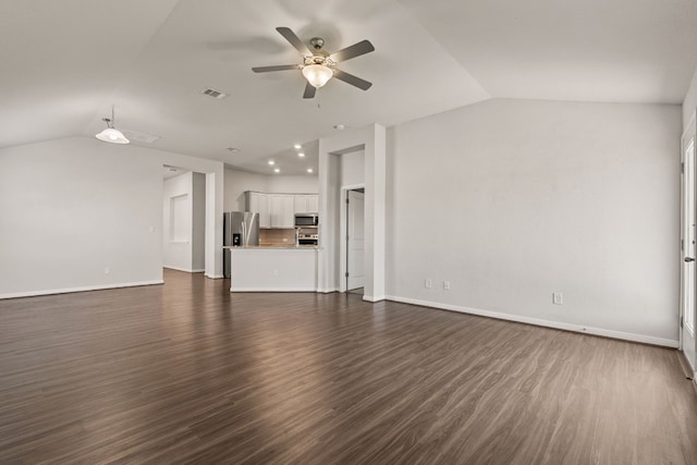 unfurnished living room with dark wood-type flooring, vaulted ceiling, and ceiling fan