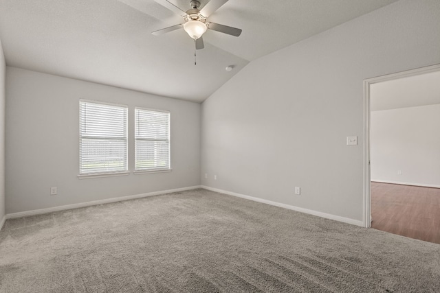 carpeted spare room with lofted ceiling and ceiling fan