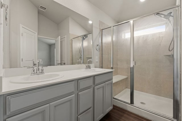 bathroom featuring a shower with door, wood-type flooring, and vanity