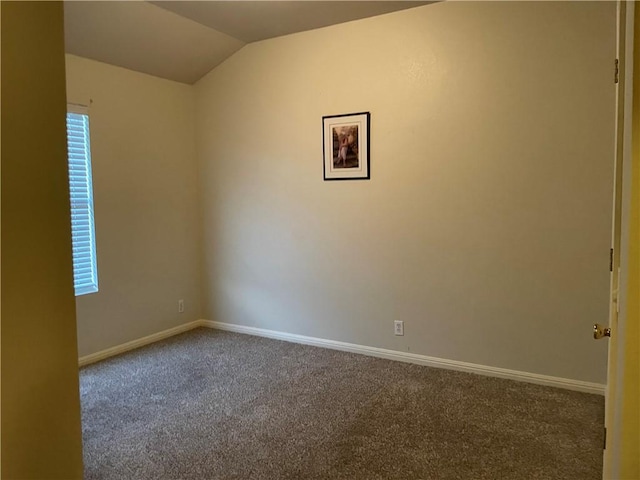 empty room with vaulted ceiling and carpet