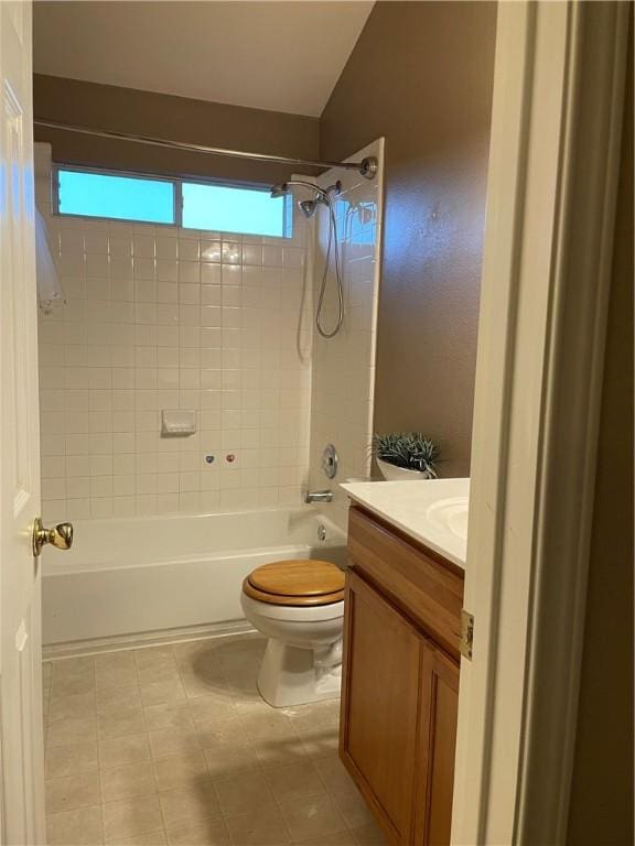 full bathroom featuring tiled shower / bath combo, vanity, and toilet