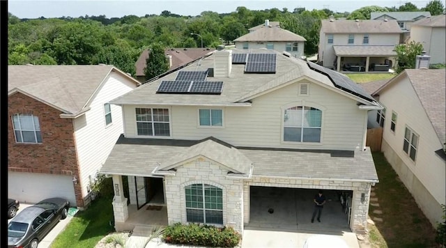 view of front facade featuring a garage and solar panels