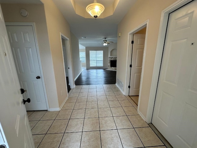 corridor featuring light tile patterned floors