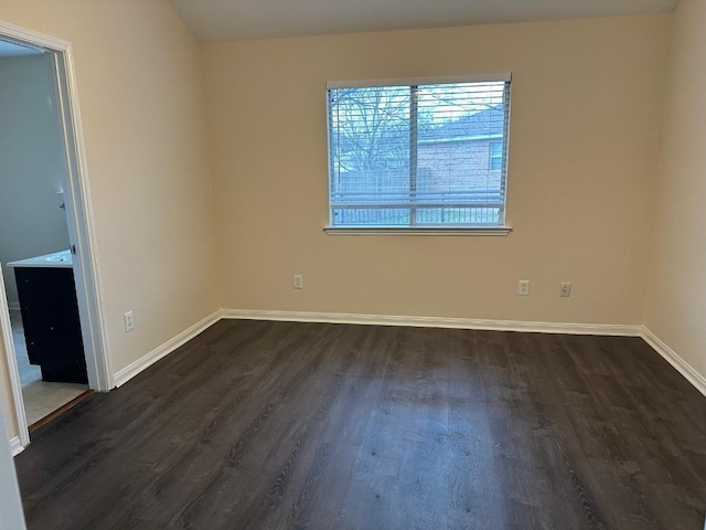 unfurnished room with dark hardwood / wood-style floors