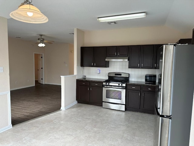 kitchen with ceiling fan, appliances with stainless steel finishes, dark stone countertops, decorative backsplash, and decorative light fixtures