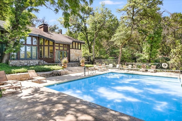 view of swimming pool featuring a patio area