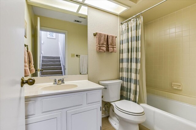 full bathroom with shower / bathtub combination with curtain, vanity, and toilet