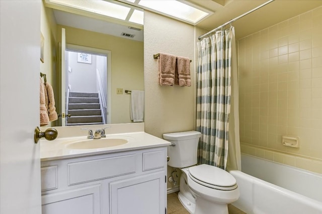 full bathroom featuring shower / bathtub combination with curtain, visible vents, vanity, and toilet