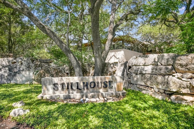 community / neighborhood sign with a lawn