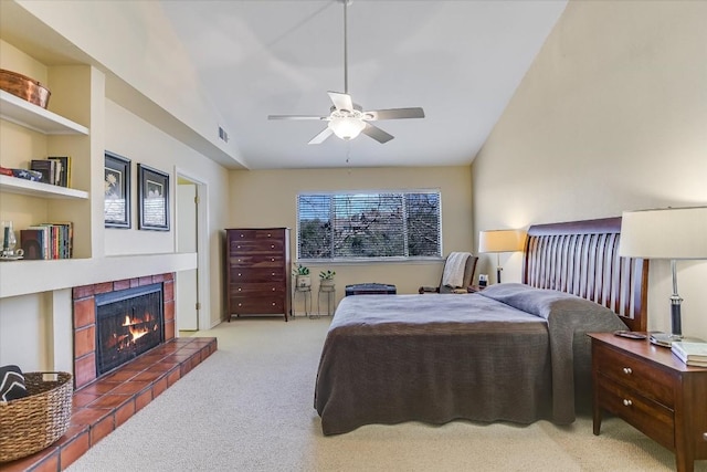 carpeted bedroom featuring ceiling fan, a fireplace, and vaulted ceiling