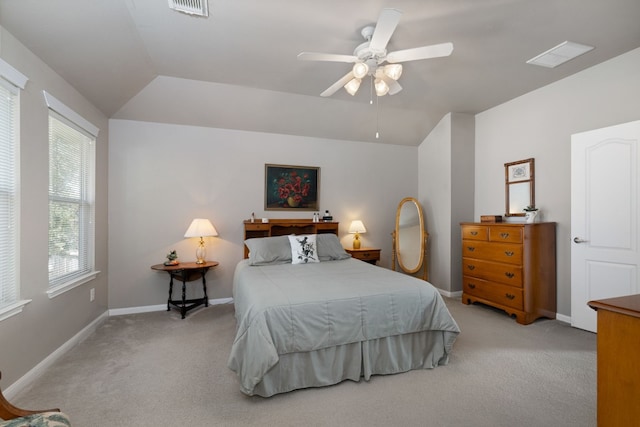 bedroom with vaulted ceiling, light carpet, and ceiling fan