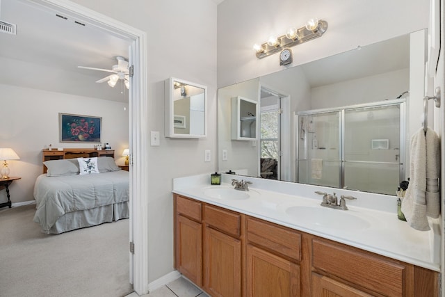 bathroom featuring ceiling fan, vanity, and a shower with door