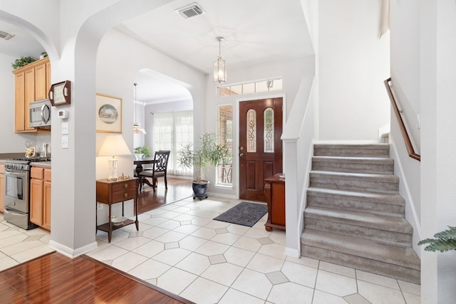 entrance foyer featuring an inviting chandelier and light hardwood / wood-style flooring