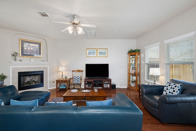 living room with ceiling fan, a fireplace, and dark hardwood / wood-style flooring