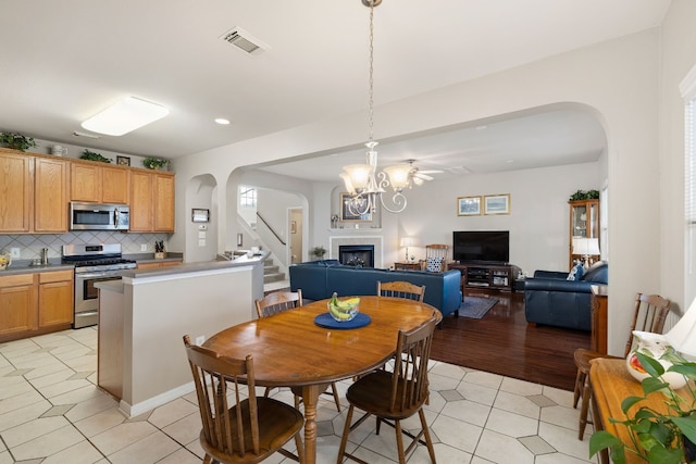 dining area with light tile patterned floors and an inviting chandelier