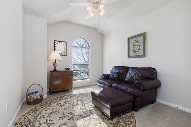 sitting room with vaulted ceiling, light colored carpet, and ceiling fan