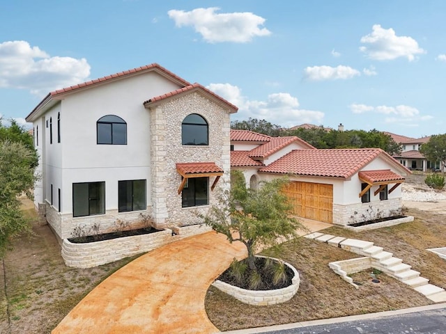 mediterranean / spanish-style home with a garage