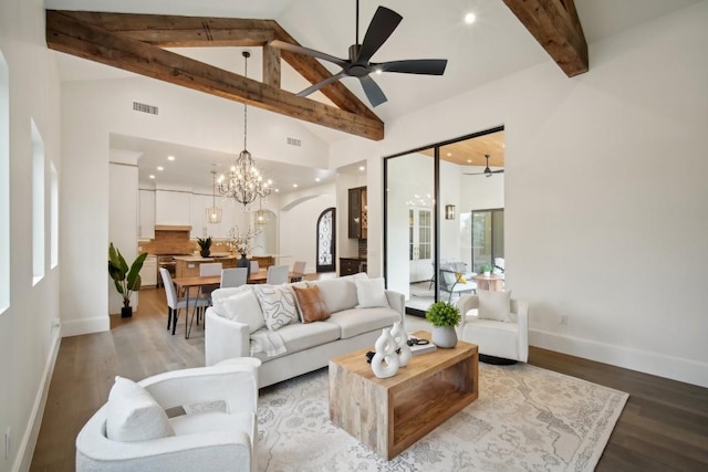 living room with beamed ceiling, high vaulted ceiling, light hardwood / wood-style floors, and ceiling fan with notable chandelier