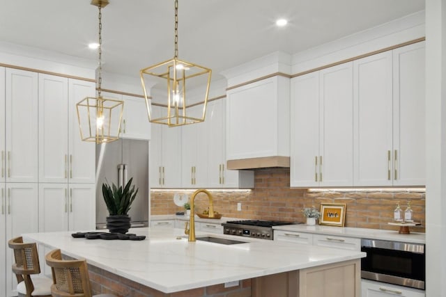 kitchen featuring stainless steel appliances, an island with sink, and white cabinets