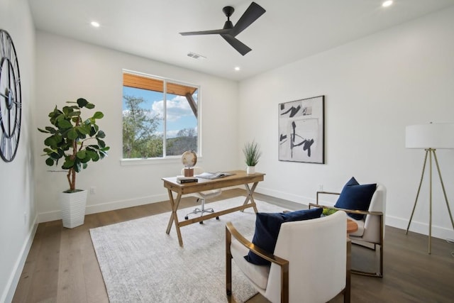 office with ceiling fan and dark hardwood / wood-style flooring