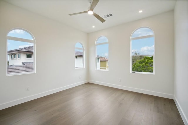 spare room with hardwood / wood-style flooring and ceiling fan