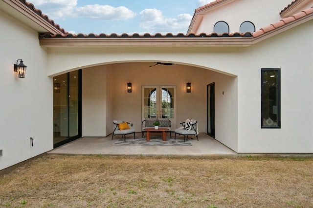 exterior space with a yard, a patio area, french doors, and ceiling fan