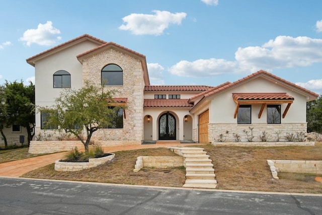 mediterranean / spanish home with a garage