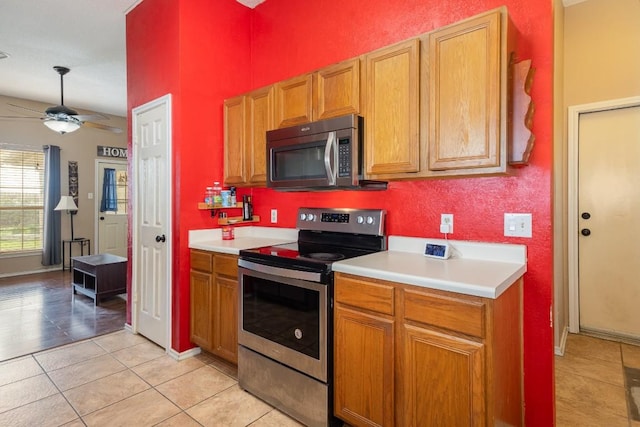 kitchen featuring ceiling fan, appliances with stainless steel finishes, and light tile patterned floors