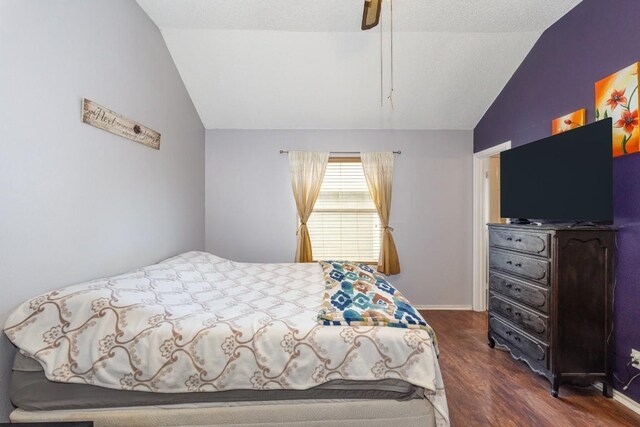 bedroom with ceiling fan, lofted ceiling, and dark hardwood / wood-style flooring