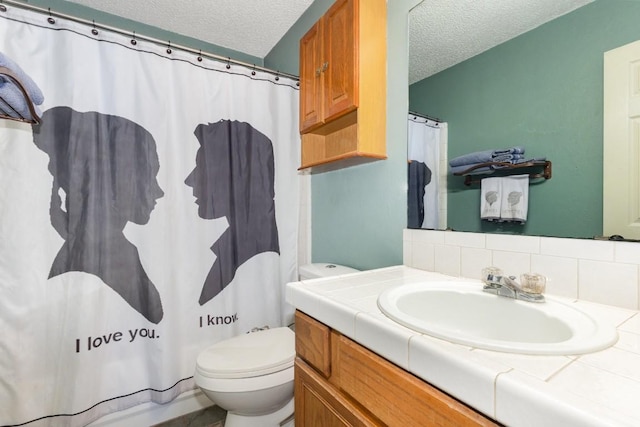 bathroom featuring vanity, decorative backsplash, toilet, and a textured ceiling