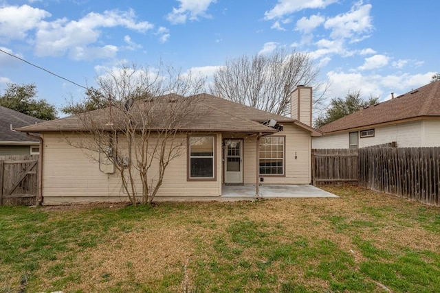 back of property featuring a patio and a lawn