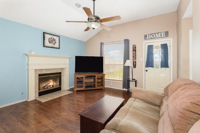 living room featuring ceiling fan, lofted ceiling, wood-type flooring, and a fireplace