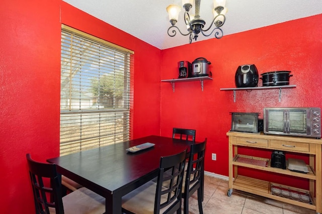 tiled dining space featuring a notable chandelier