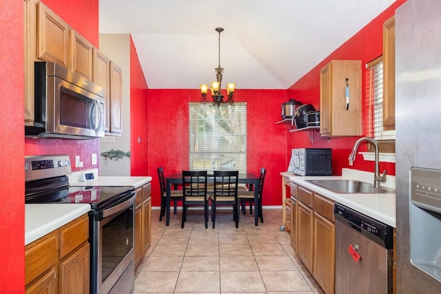 kitchen with pendant lighting, sink, stainless steel appliances, vaulted ceiling, and a chandelier