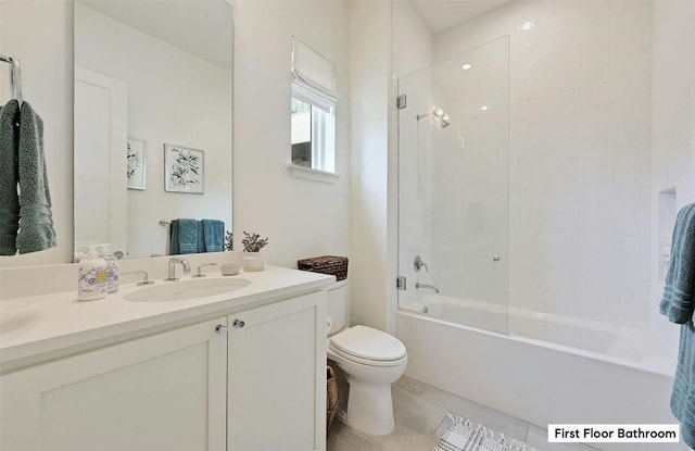 full bathroom with vanity, tile patterned floors, toilet, and washtub / shower combination