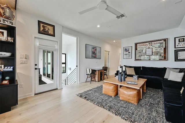 living room with ceiling fan and light wood-type flooring