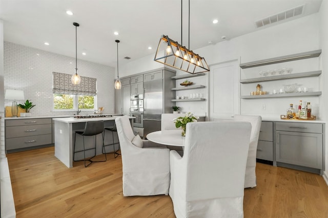 dining room featuring light hardwood / wood-style floors and indoor bar