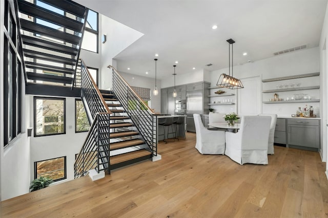 dining area with bar and light wood-type flooring