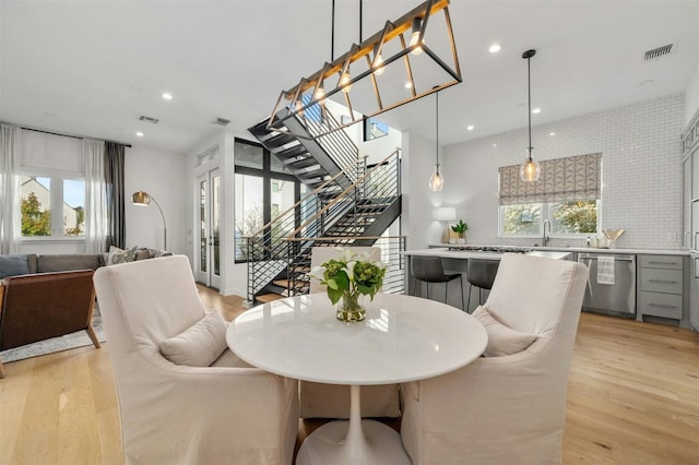 dining area with sink and light wood-type flooring